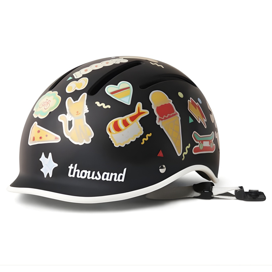 Casque vélo enfant Thousand Jr noir décoré d’autocollants, vue trois quarts