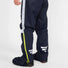 Pantalon de pluie Urban Circus Iyuc bleu marine avec bandes réfléchissantes latérales pour cyclistes urbains.