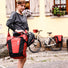 Sacoches arriere Ortlieb Back Roller Pro Plus 2 x 35L rouge en usage urbain avec velo en arriere-plan