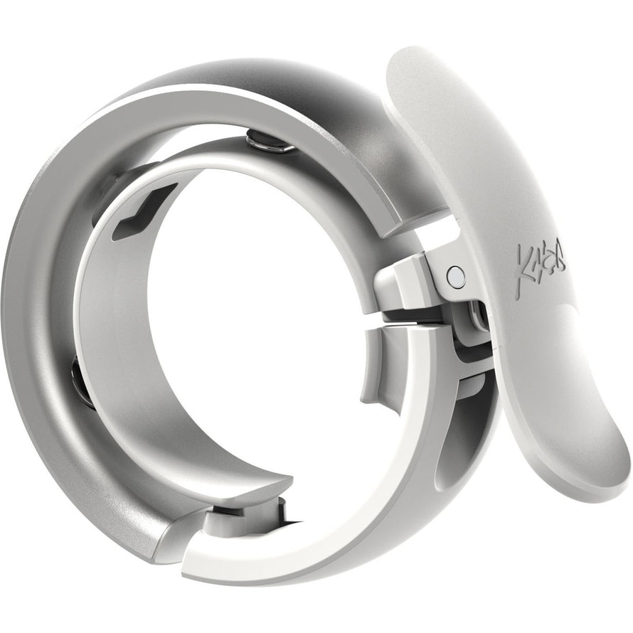 Sonnette vélo Knog Oi Bell Prima Large blanche mate, design épuré et montage rapide sur guidon